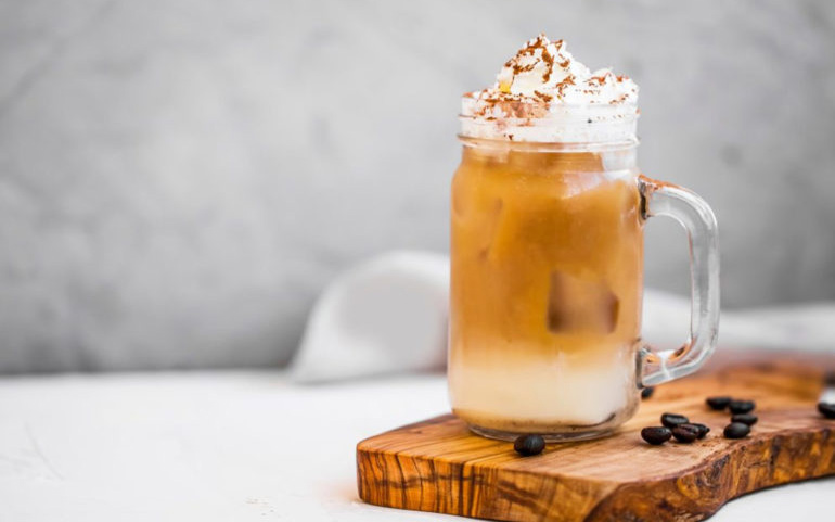 high-calorie huge glass of cold brew coffee with a lot of cream